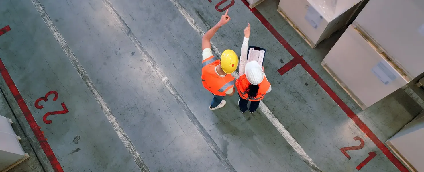 ACF workers in warehouse discussing contract logisitics