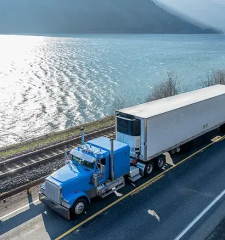 Truck driving by water