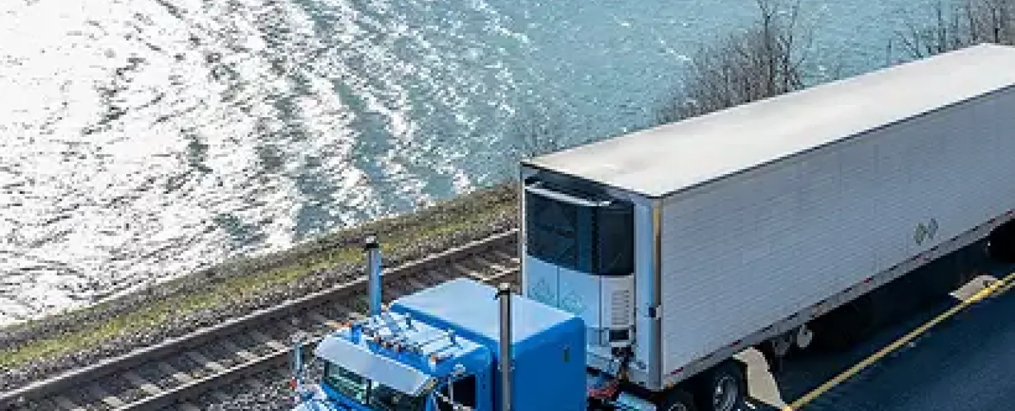 Truck driving by water